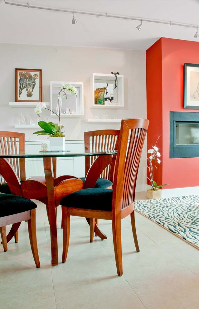 Exemple d'une salle à manger ouverte sur le salon chic de taille moyenne avec un mur blanc, un sol en carrelage de porcelaine et une cheminée standard.