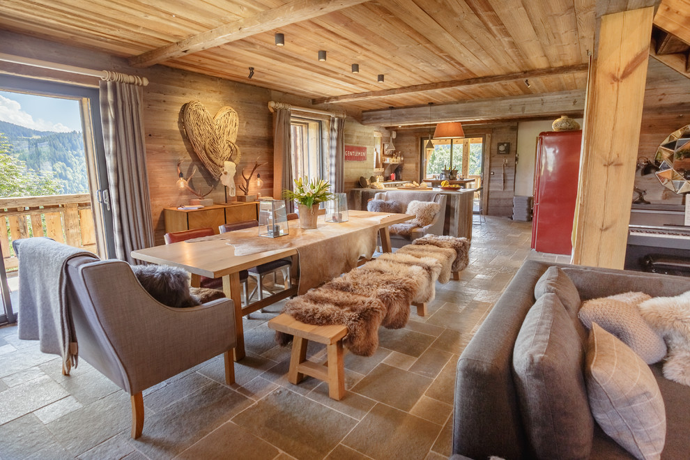 Photo of a rustic open plan dining room in London with brown floors.