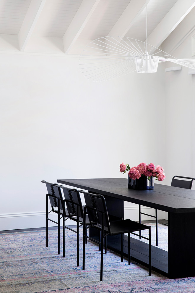 Immagine di una sala da pranzo design con pareti bianche, parquet scuro e pavimento nero