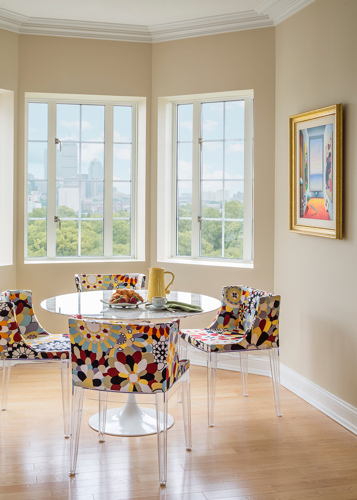 Example of a mid-sized eclectic light wood floor and brown floor kitchen/dining room combo design in Boston with beige walls and no fireplace