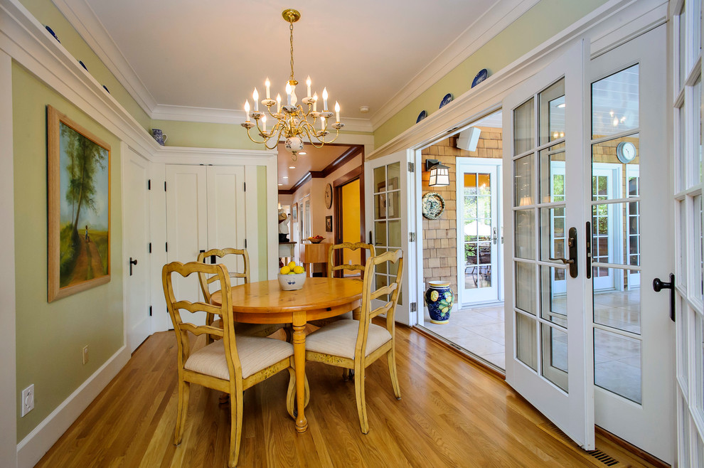 Traditional dining room in San Francisco with green walls and medium hardwood flooring.