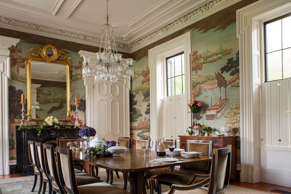Enclosed dining room - victorian medium tone wood floor enclosed dining room idea in Charleston with multicolored walls and a standard fireplace