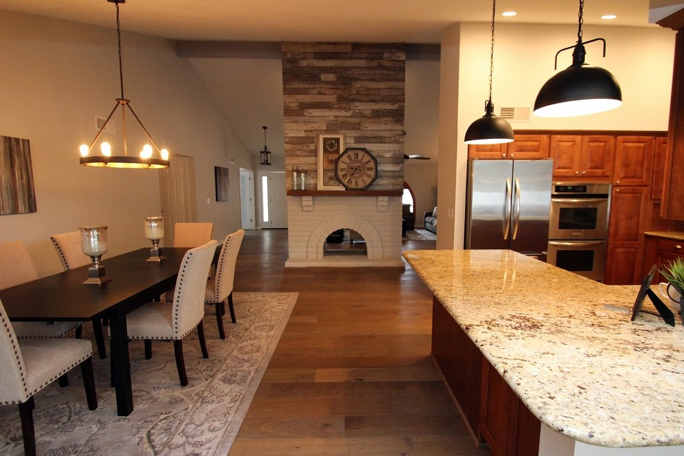 Example of a transitional great room design in Phoenix with a two-sided fireplace and a brick fireplace