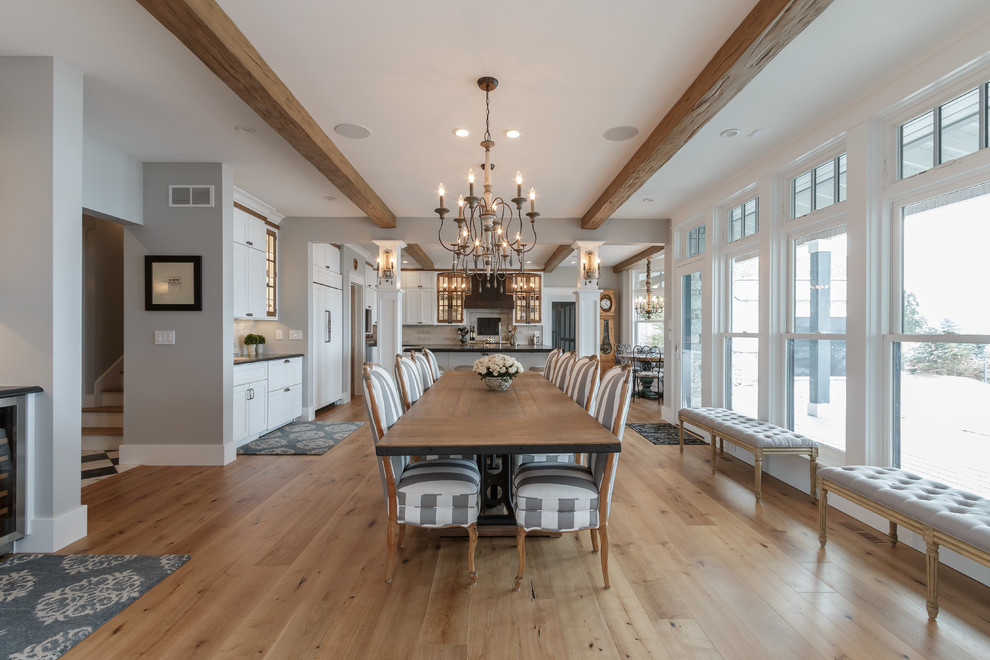 Design ideas for a large traditional open plan dining room in Other with medium hardwood flooring, grey walls and brown floors.