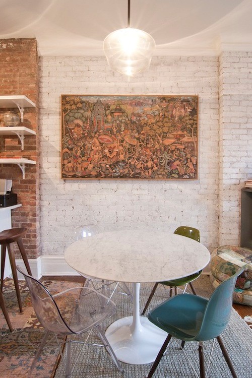 Imagen de comedor de cocina moderno pequeño con paredes blancas, suelo de madera en tonos medios, todas las chimeneas, marco de chimenea de piedra y suelo marrón