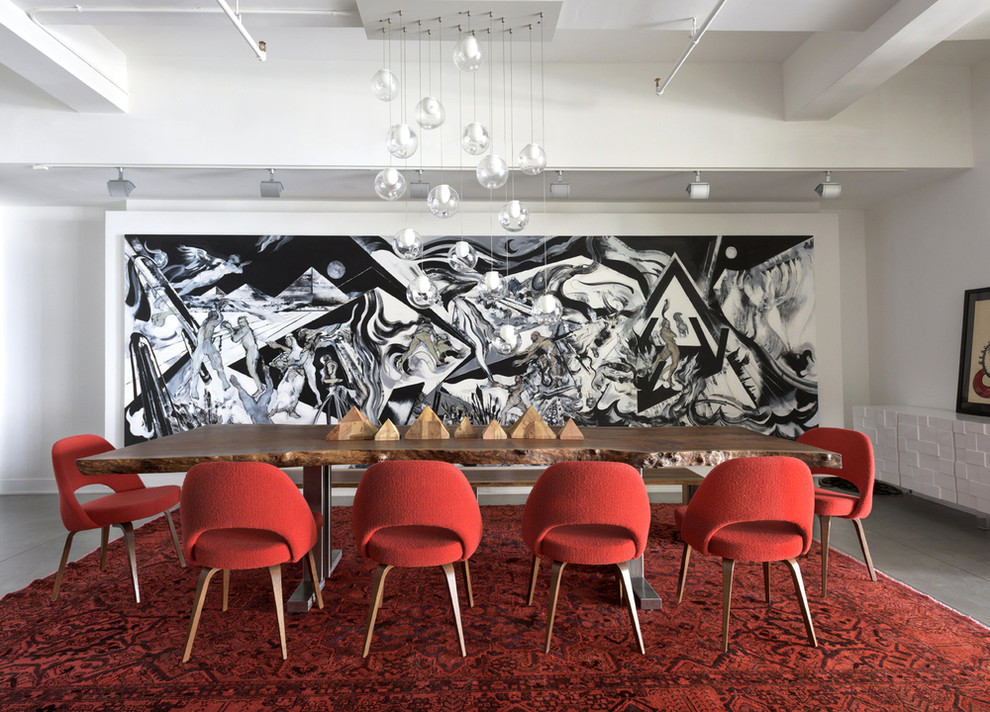 Immagine di una grande sala da pranzo minimal con pareti bianche e pavimento in cemento