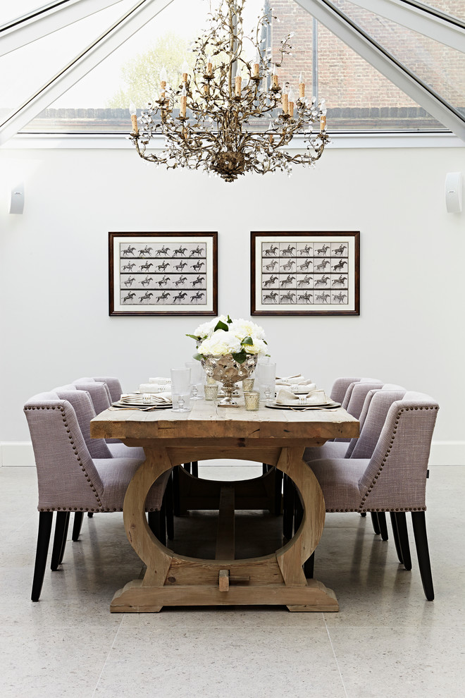 Inspiration for a transitional dining room remodel in London with white walls and no fireplace