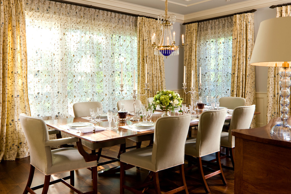 This is an example of a classic dining room in Denver with grey walls.