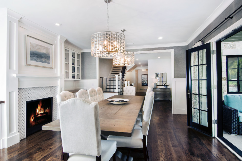 Design ideas for a large classic enclosed dining room in Denver with grey walls, dark hardwood flooring, a standard fireplace, a tiled fireplace surround and brown floors.