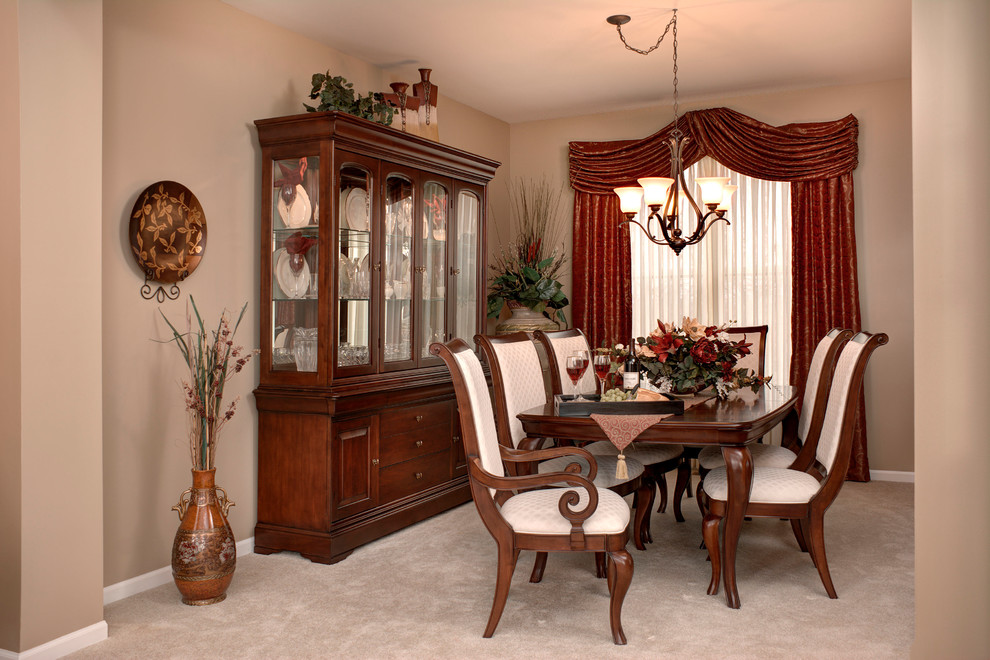 Small elegant carpeted enclosed dining room photo in Chicago with beige walls and no fireplace