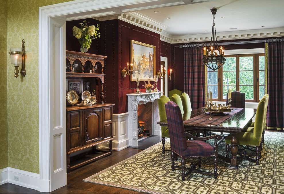 Idées déco pour une salle à manger victorienne fermée et de taille moyenne avec un mur rouge, parquet foncé, une cheminée standard, un manteau de cheminée en pierre et un sol marron.