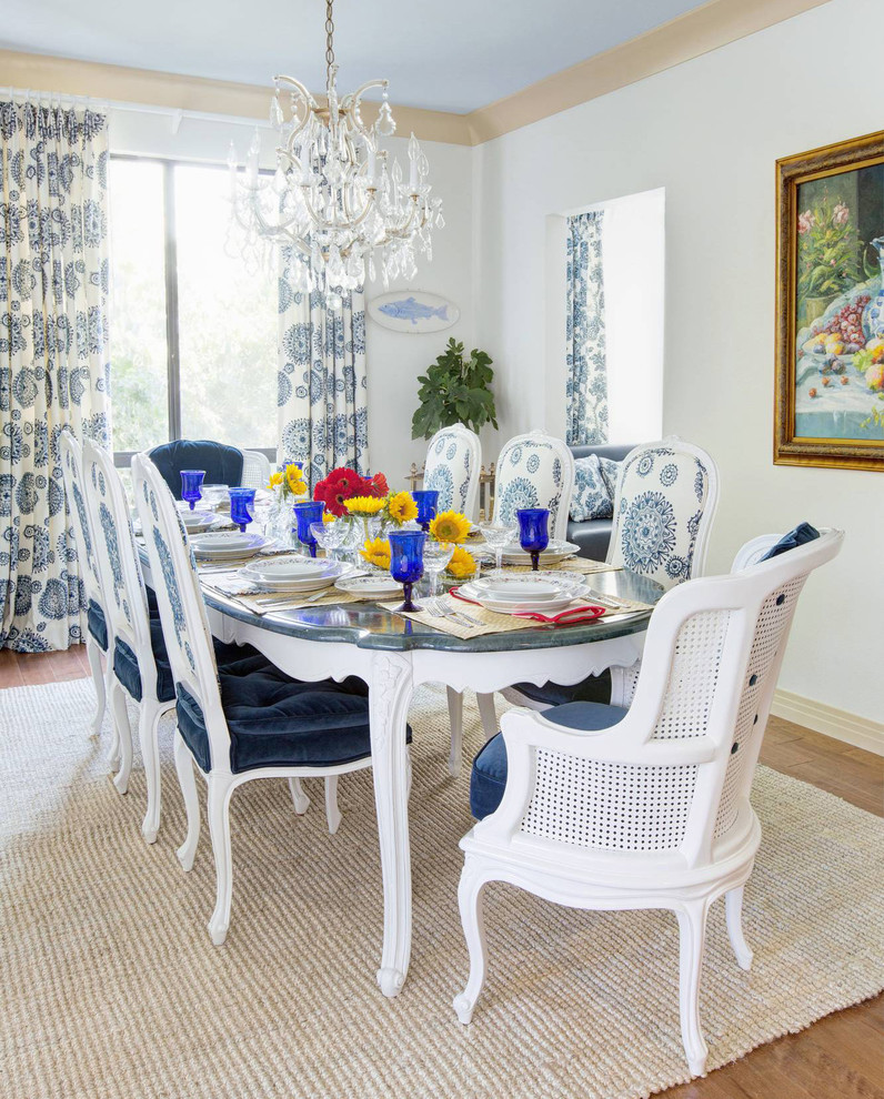 Mid-sized elegant medium tone wood floor enclosed dining room photo in San Francisco with white walls