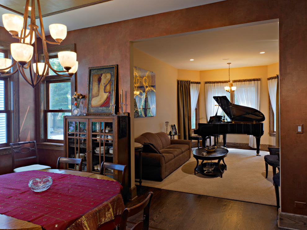 This is an example of a medium sized classic dining room in Chicago with dark hardwood flooring and brown walls.