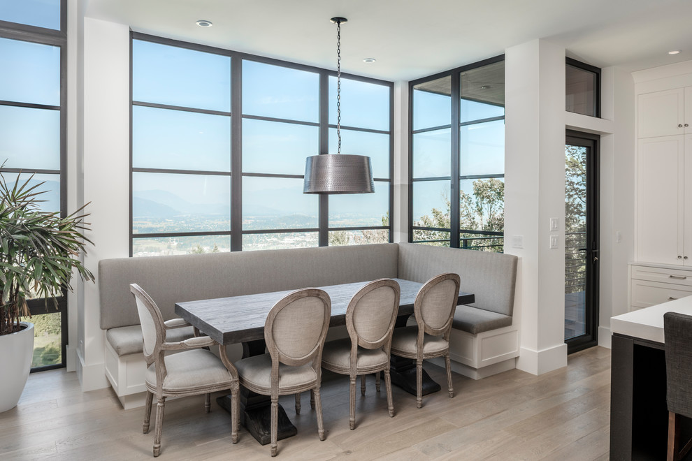 Mid-sized trendy light wood floor great room photo in Vancouver with white walls and no fireplace