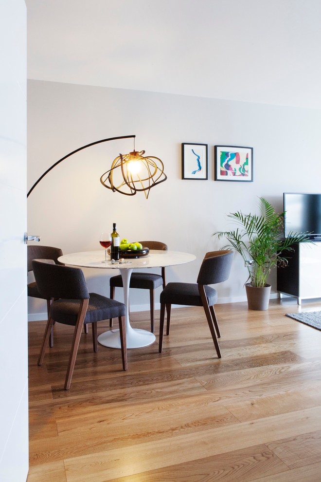 Photo of a contemporary dining room in London with feature lighting.