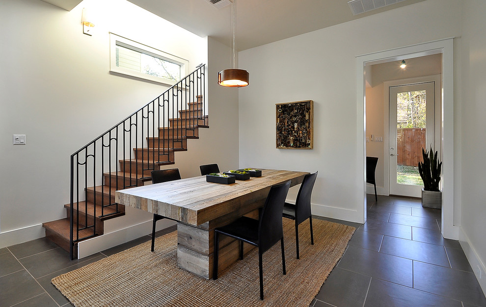 Example of a trendy dining room design in Austin with white walls