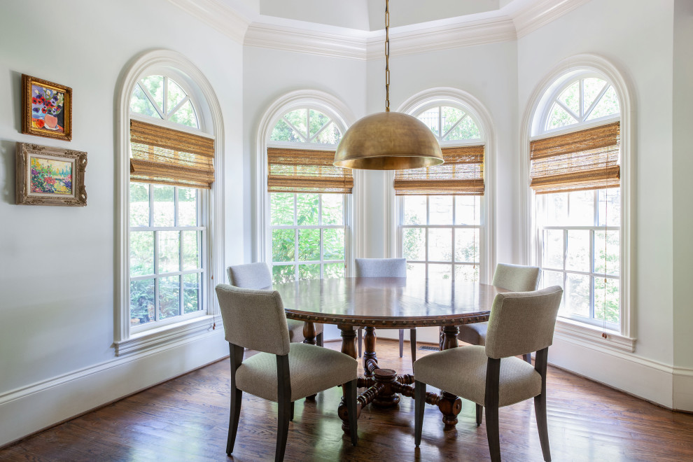 Example of a transitional dark wood floor and brown floor dining room design in Atlanta with white walls