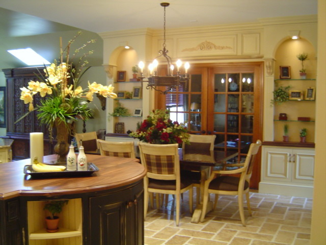 Kitchen/dining room combo - large traditional travertine floor kitchen/dining room combo idea in New York with yellow walls and no fireplace