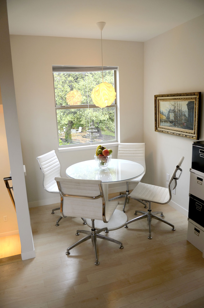Inspiration for a contemporary light wood floor dining room remodel in Austin with white walls