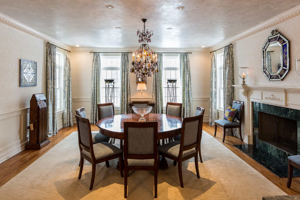 Inspiration for a large transitional carpeted enclosed dining room remodel in New York with beige walls, a standard fireplace and a wood fireplace surround