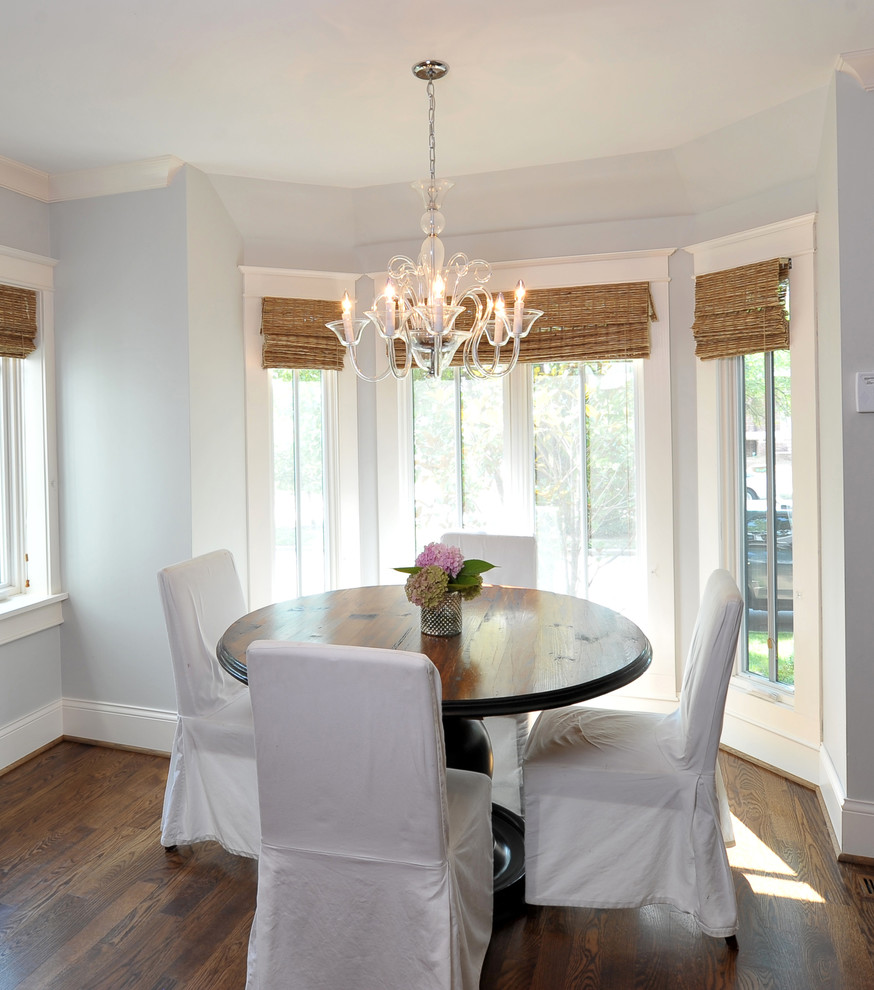 This is an example of a traditional dining room in St Louis with white walls and dark hardwood flooring.