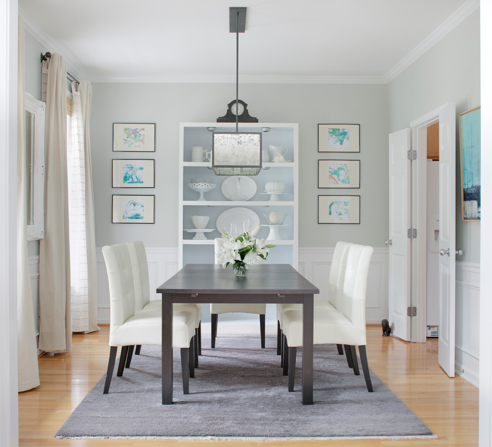 Inspiration for a coastal dining room in Raleigh with light hardwood flooring and grey walls.