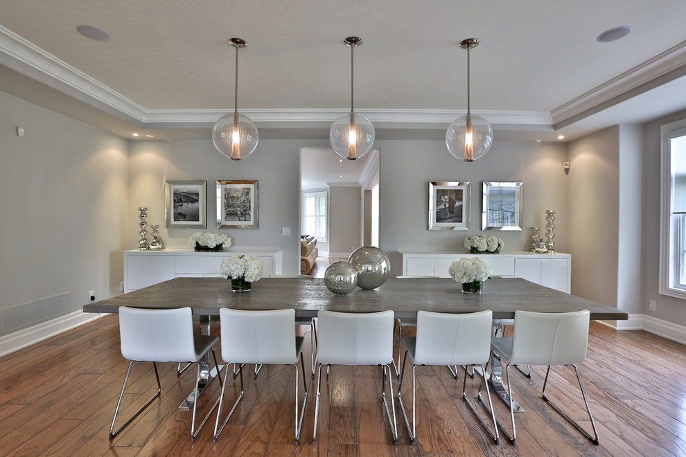 Enclosed dining room - contemporary medium tone wood floor enclosed dining room idea in Toronto with gray walls