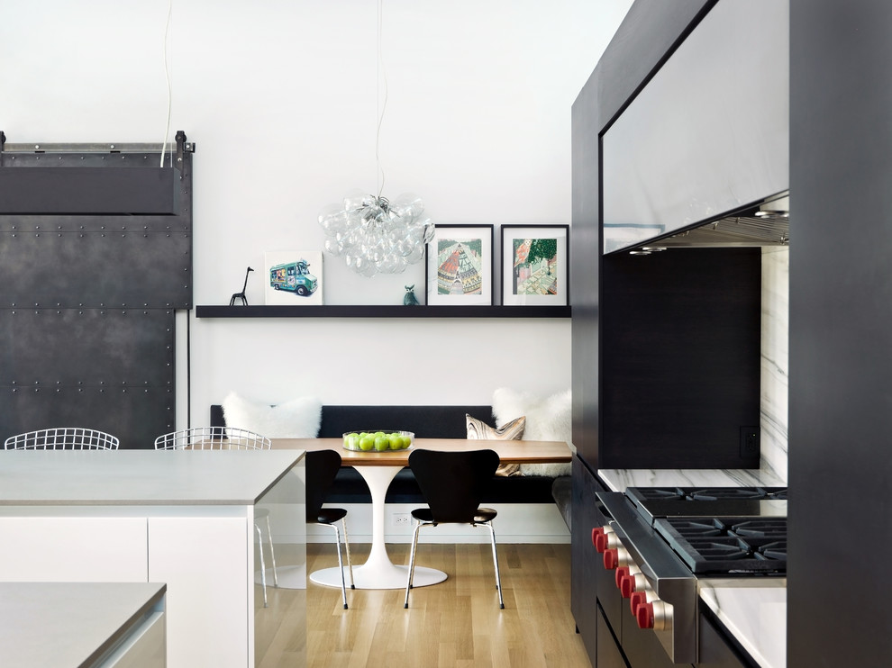 Inspiration pour une salle à manger ouverte sur la cuisine nordique avec un mur blanc et parquet clair.