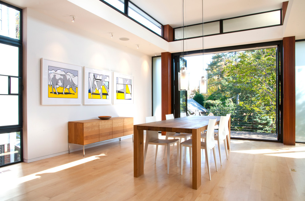 Inspiration for a contemporary light wood floor dining room remodel in DC Metro with white walls