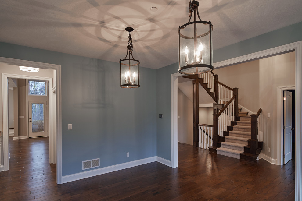 This is an example of a large classic enclosed dining room in Cleveland with blue walls, medium hardwood flooring, no fireplace and brown floors.