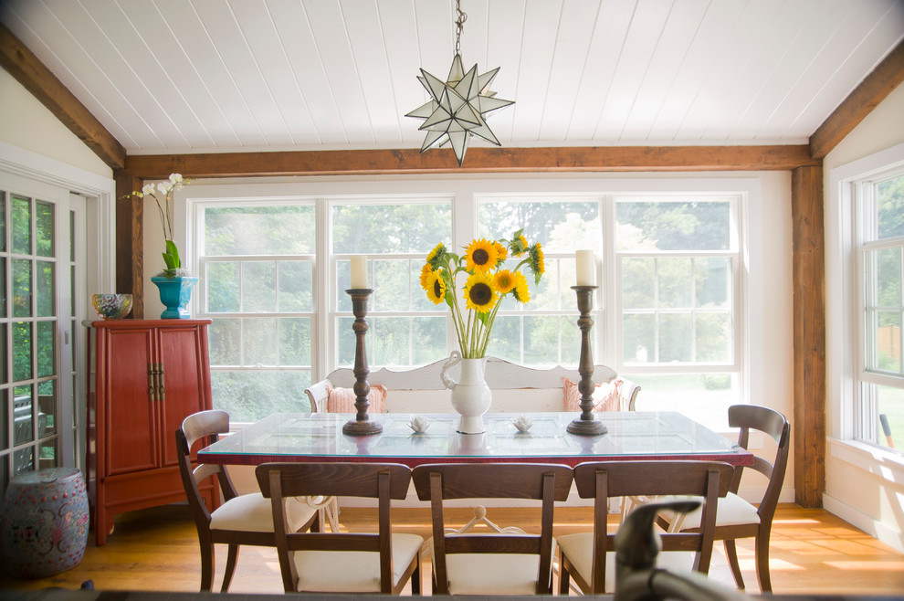 This is an example of a medium sized traditional enclosed dining room in Boston with medium hardwood flooring, white walls and no fireplace.