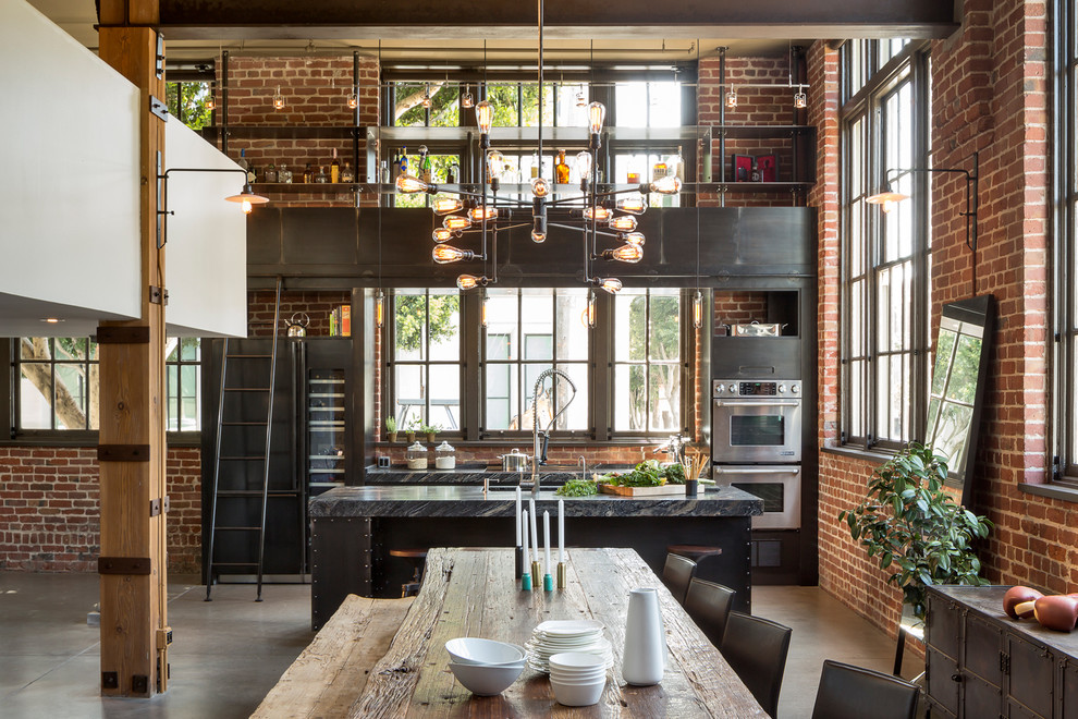 Mid-sized urban concrete floor kitchen/dining room combo photo in San Francisco with multicolored walls and no fireplace