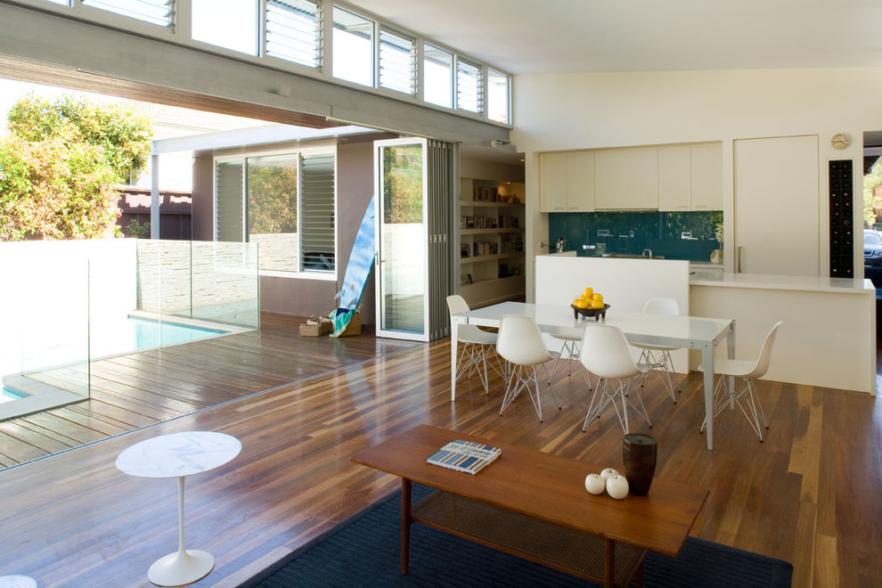 Contemporary dining room in Sydney with white walls and medium hardwood flooring.