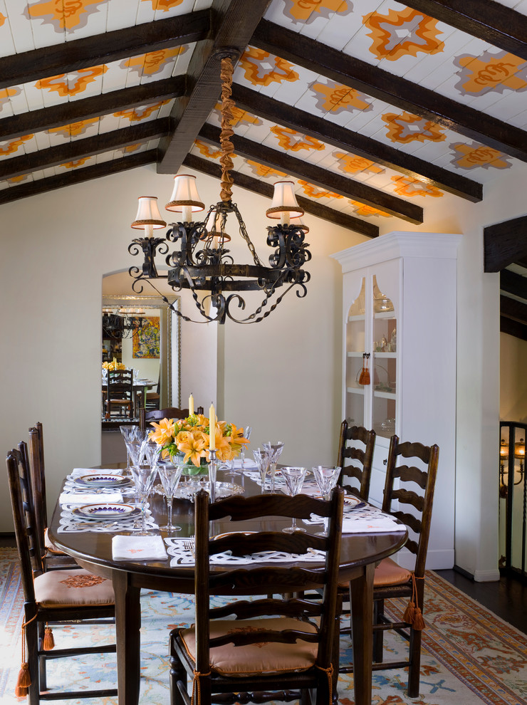 Traditional dining room in Santa Barbara with white walls and dark hardwood flooring.