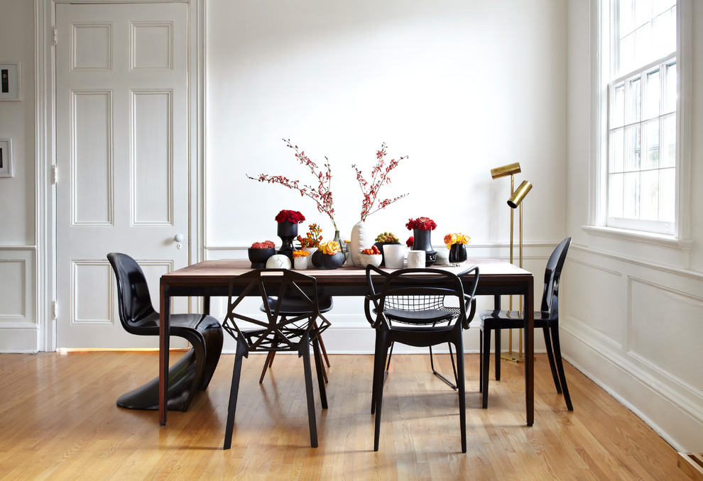 Eclectic medium tone wood floor dining room photo in Toronto with white walls and no fireplace