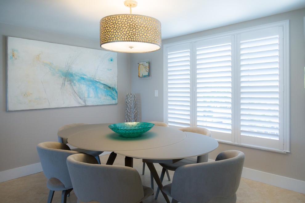 This is an example of a medium sized nautical open plan dining room in Miami with beige walls, no fireplace and beige floors.
