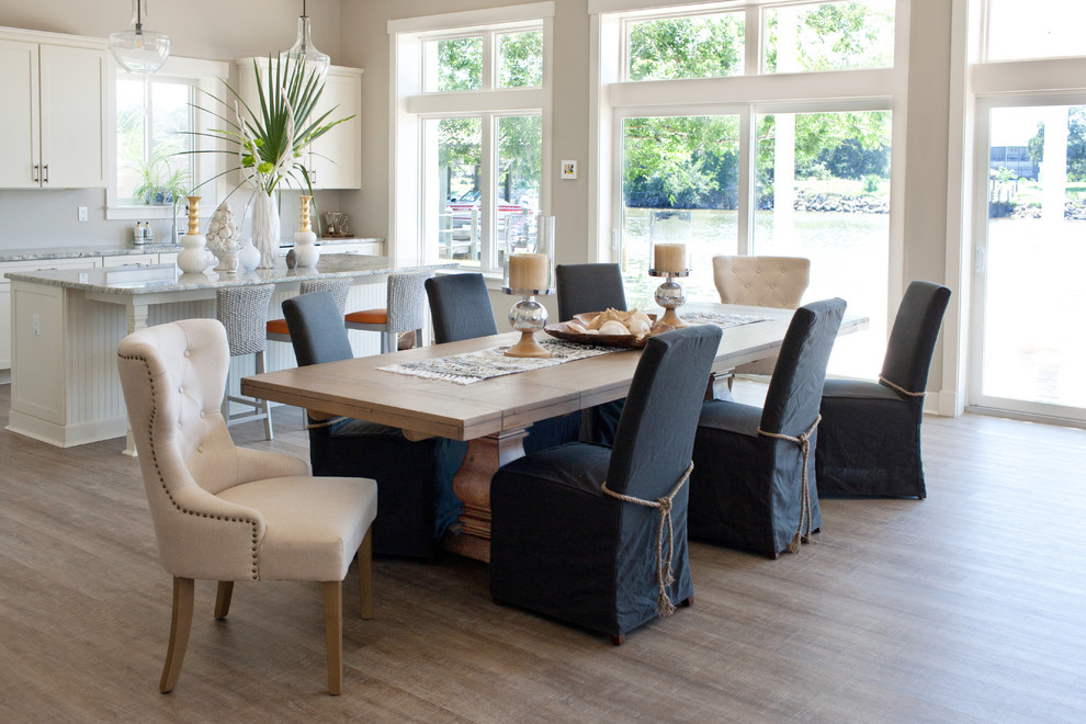 This is an example of a large beach style kitchen/dining room in Orlando with grey walls, vinyl flooring and grey floors.