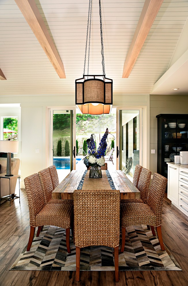 Esempio di una sala da pranzo aperta verso il soggiorno costiera con pavimento in legno massello medio