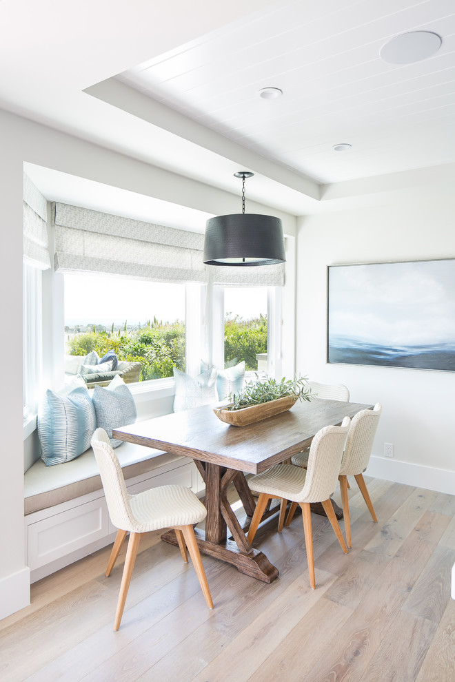 Design ideas for a coastal dining room in Los Angeles with grey walls, light hardwood flooring and no fireplace.