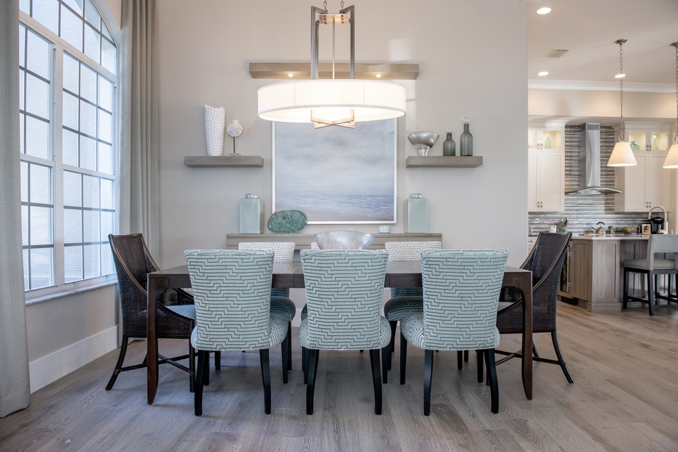 Design ideas for a large classic enclosed dining room in Miami with grey walls and light hardwood flooring.