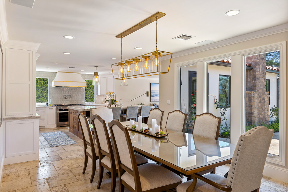This is an example of a large mediterranean kitchen/dining room in Los Angeles with beige walls, ceramic flooring and beige floors.