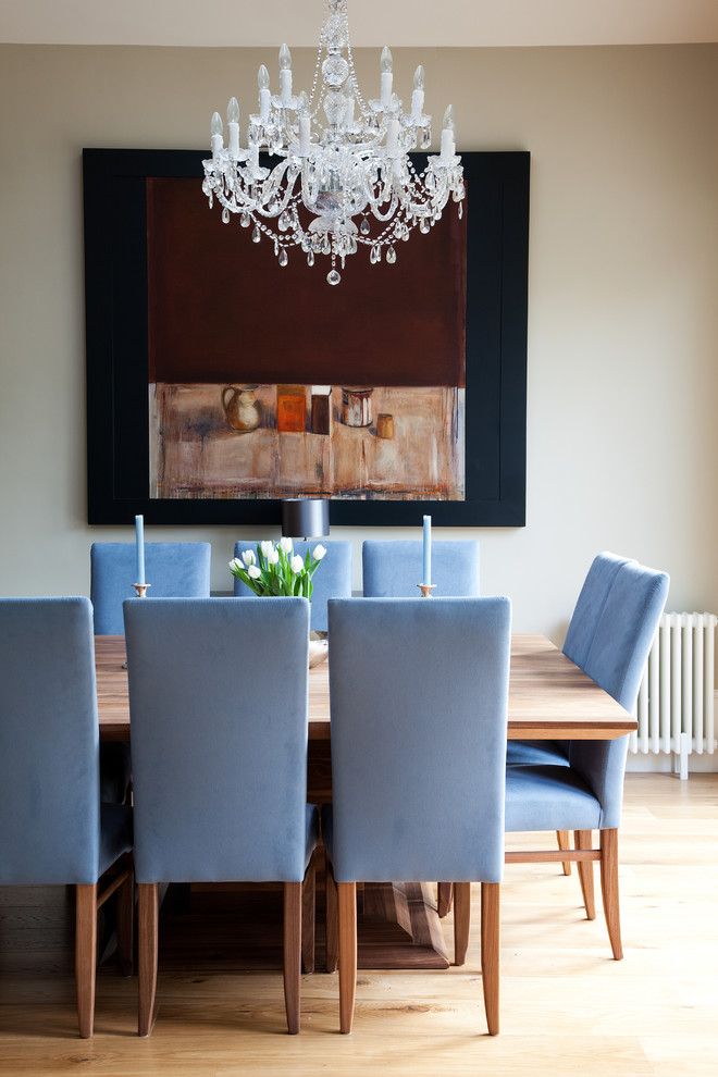 Immagine di una sala da pranzo classica con pareti grigie e pavimento in legno massello medio