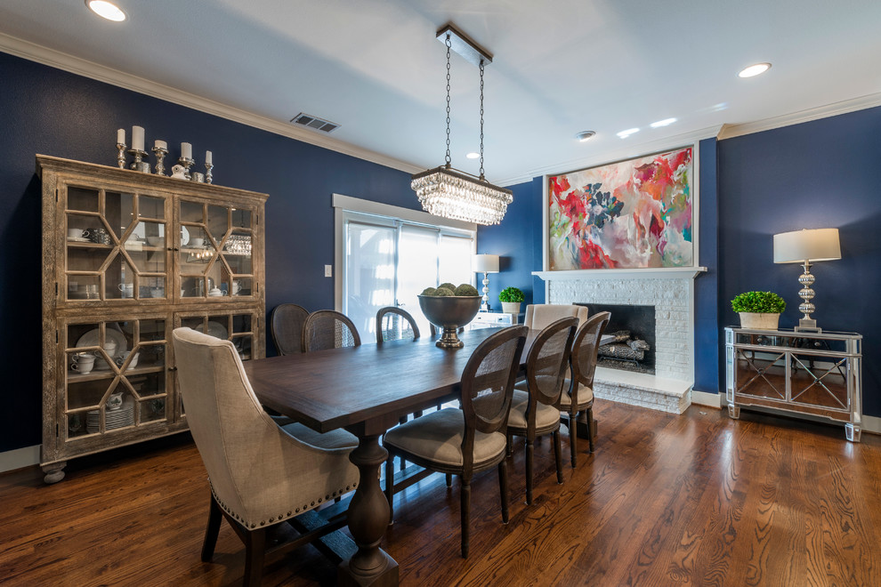 Classic kitchen/dining room in Dallas with blue walls, medium hardwood flooring, a standard fireplace and a stone fireplace surround.