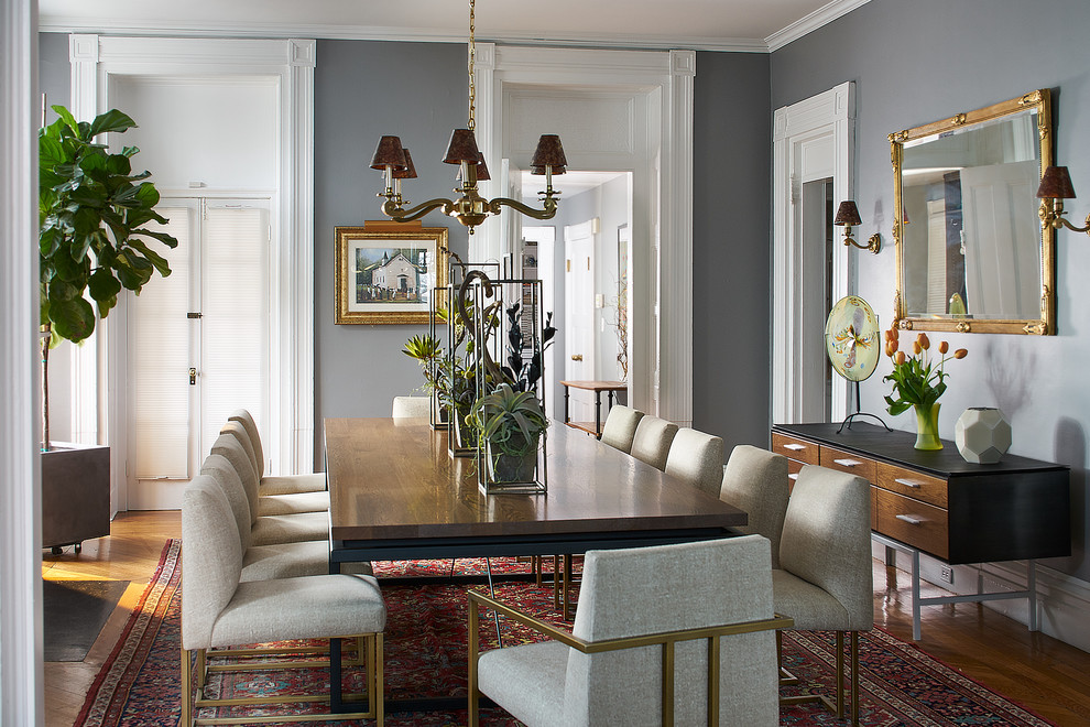 Transitional medium tone wood floor enclosed dining room photo in New York with gray walls