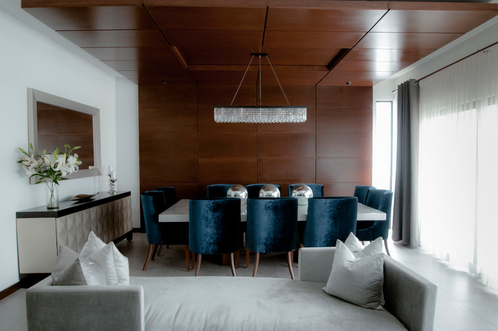Esempio di una sala da pranzo aperta verso il soggiorno minimal di medie dimensioni con pareti bianche, pavimento in gres porcellanato e pavimento grigio