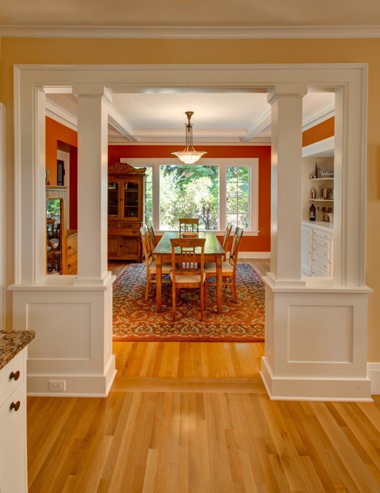 Enclosed dining room - craftsman medium tone wood floor enclosed dining room idea in Portland with red walls