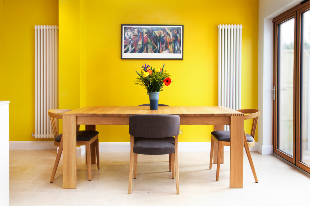 Contemporary dining room in London with yellow walls.