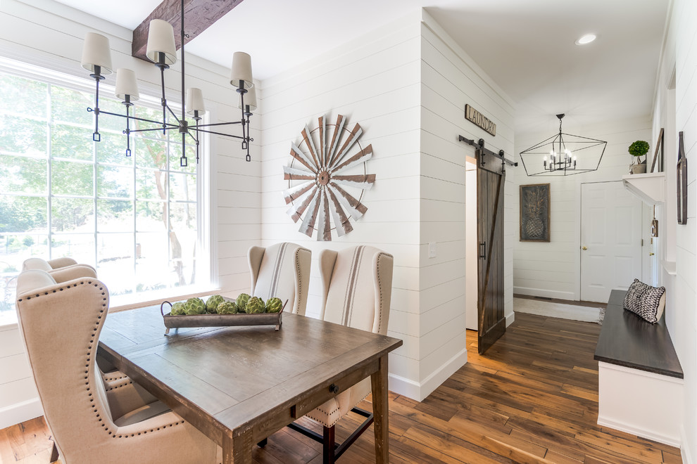 Esempio di una sala da pranzo aperta verso la cucina country con pareti bianche, pavimento in legno massello medio e pavimento marrone