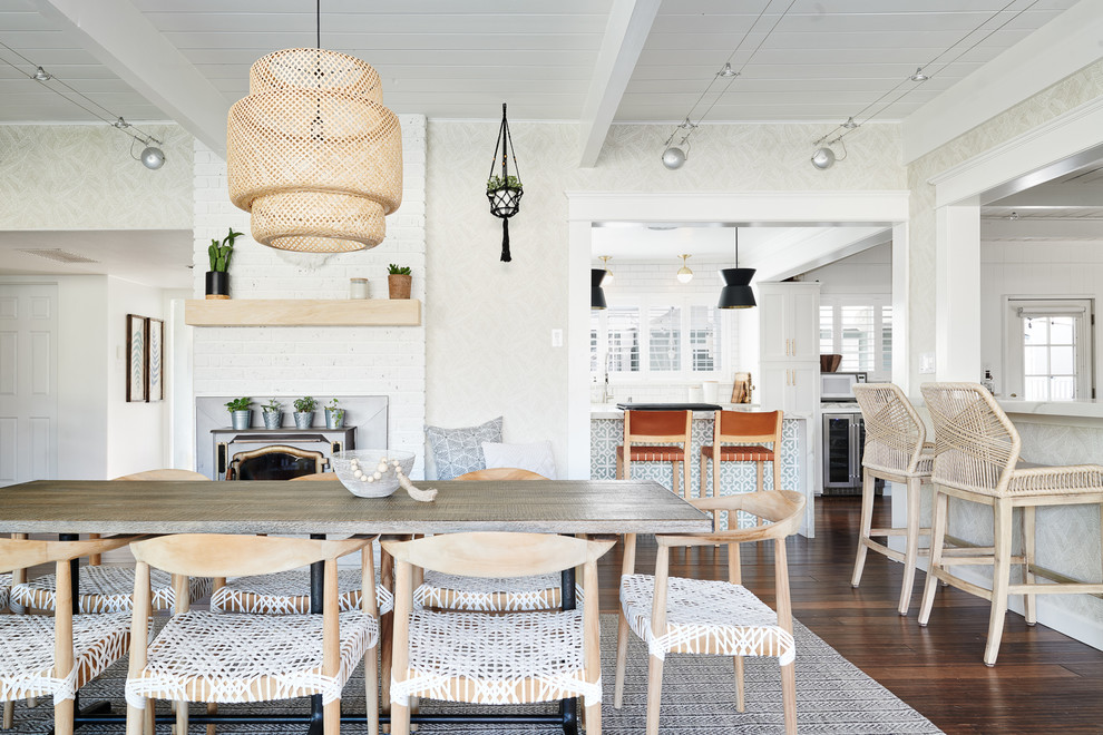 Nautical dining room in San Francisco with beige walls, dark hardwood flooring, a wood burning stove and brown floors.