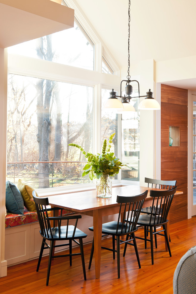 Farmhouse dining room in Boston with white walls and medium hardwood flooring.